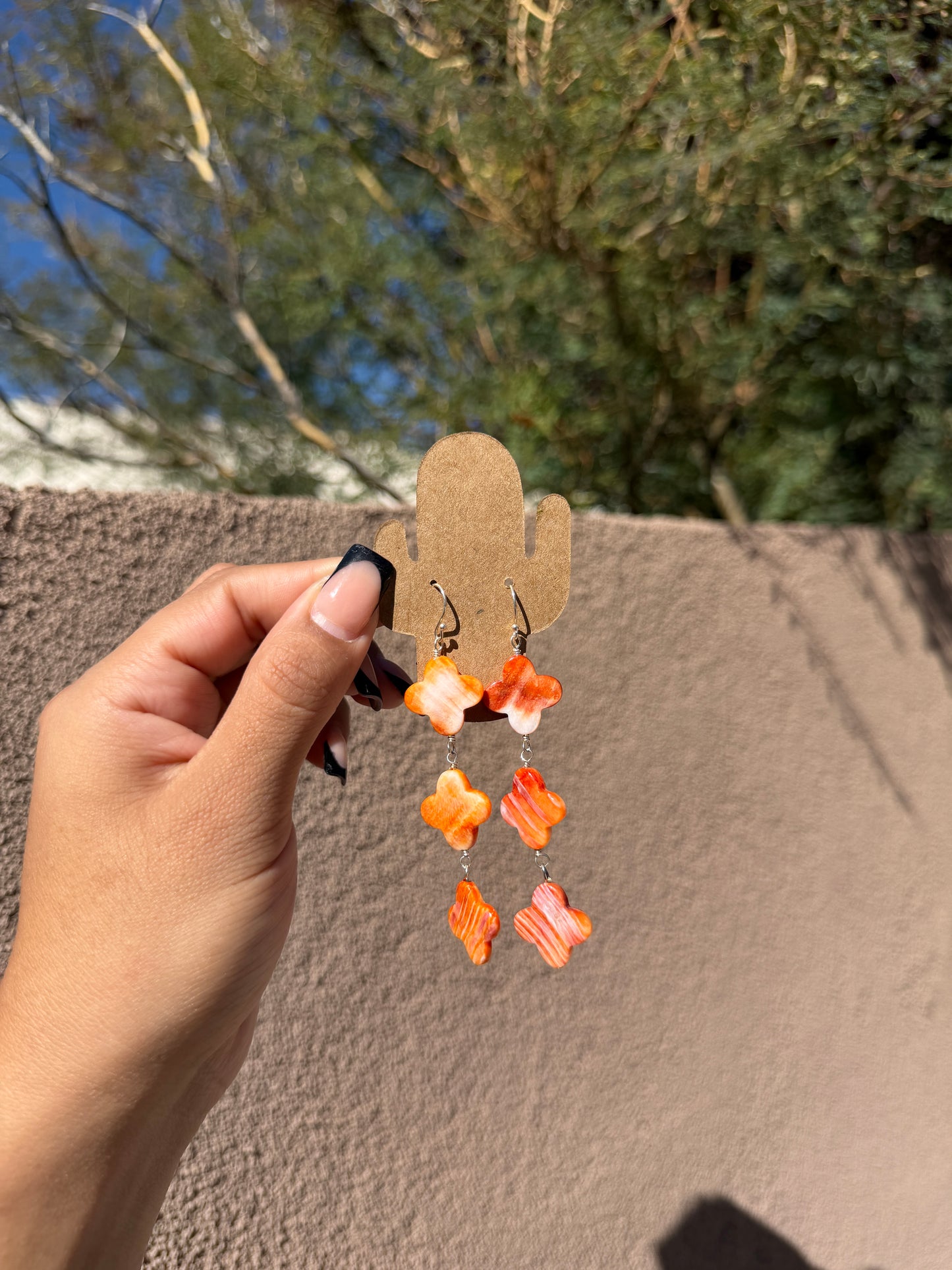 Orange spiny clover dangle earrings